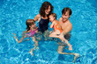 Happy family with kids in swimming pool. Summer vacation