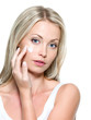 Beautiful woman applying cream