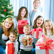 Happy Big family holding Christmas presents at home