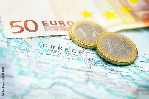 Photo: Closeup of Euro coins on a map of Greece Closeup of Euro coins on a map of Greece