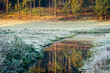 Sunrise at frozen meadow in fall