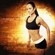 Athletic woman on golden background.