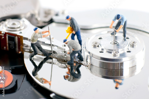 Photo: Group of workers repair hard drive Group of workers repair hard drive