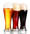 three glasses with different beers isolated on white