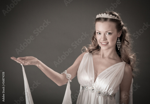 Photo: female wearing white dress in antique style . female wearing white dress in antique style .