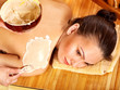 Young woman  having clay body mask.