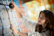 teenage girl portrait with spray can near graffiti wall