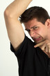 Man smelling bady under he's armpits