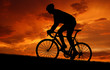 Photo: silhouette of the cyclist riding a road bike at sunset silhouette of the cyclist riding a road bike at sunset