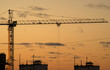 Crane and the contours of house under construction sunset view