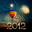 New year 2012 fireworks and hot air balloon at sunset New year 2012 fireworks and hot air balloon at sunset