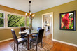 Classic dining room with leather chairs and glass table.