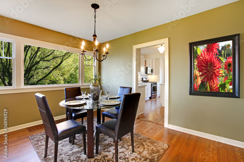 Photo: Classic dining room with leather chairs and glass table. Classic dining room with leather chairs and glass table.