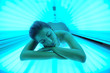 Beautiful young woman tanning in solarium