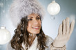 A young woman looking at a glass bauble