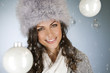 A young woman standing amongst glass baubles