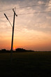 Electrical pole on sunset background