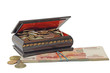 Wooden treasure chest of coins and paper money, isolated over wh Wooden treasure chest of coins and paper money, isolated over wh