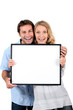 couple with blank picture frame