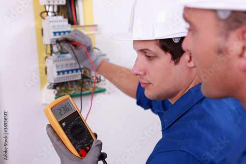 Photo: Two technical engineers checking electrical equipment Two technical engineers checking electrical equipment