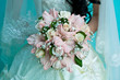 bride holding a wedding bouquet of gladioli