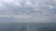 Sun road and track left by ship on water surface
