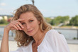 Blond woman relaxing by river front
