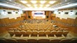 Lot of people sit on chair in hall and watch event