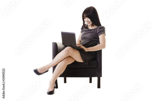 Photo: Attractive Chinese woman working on a netbook. Attractive Chinese woman working on a netbook.
