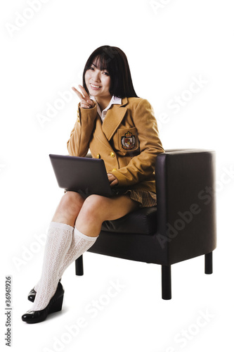 Photo: Chinese school girl working on a laptop. Chinese school girl working on a laptop.