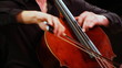 expressive young man plays cello sitting on stage, close-up