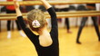girl repeats movement elbows of adults dancers standing