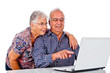 Seniors couple using a computer laptop