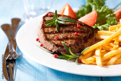 Photo: Grilled steak with french fries and salad Grilled steak with french fries and salad