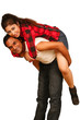 Smiling young Indian man piggybacking his pretty girlfriend -