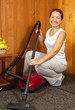 She is vacuuming the entry foyer into  home