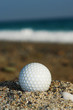 Golf Ball On The Beach, Ready To Be Hit In To The Ocean.