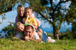 Familie mit Kindern und Fußball auf einer Wiese