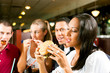 Foto: Friends eating fast food in a restaurant Friends eating fast food in a restaurant