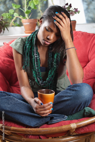Photo: Distraught woman sitting on chair Distraught woman sitting on chair