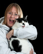 Woman and her cat laughing.