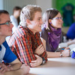 young, handsome college student sitting in a classroom
