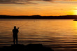 A fisherman in sunset at th acoast.