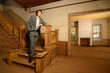 Man Standing on Stairs in an Old House