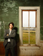 Suited man foling arms in Abandoned Home