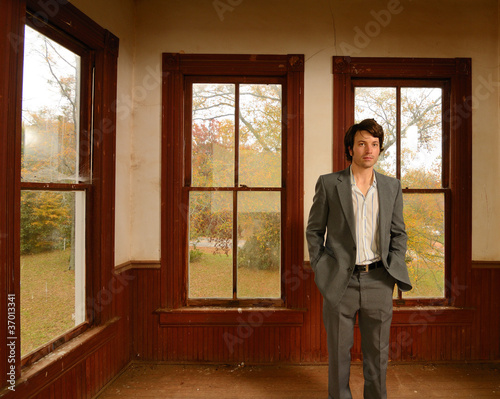Photo: Suited man in Abandoned Home Suited man in Abandoned Home