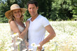 Couple in field of flowers.
