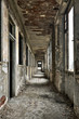 Long empty corridor and doors in abandoned building