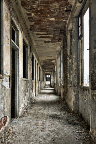 Photo: Long empty corridor and doors in abandoned building Long empty corridor and doors in abandoned building