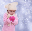 Foto: Little girl blowing snowflakes from her hands Little girl blowing snowflakes from her hands